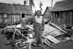 Mother and daughter in front of their destroyed house